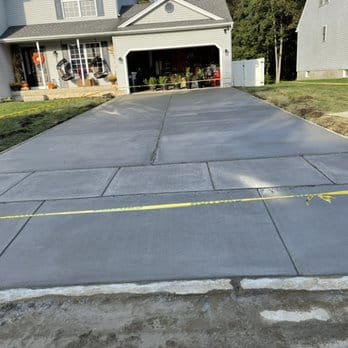 Freshly poured concrete driveway installation