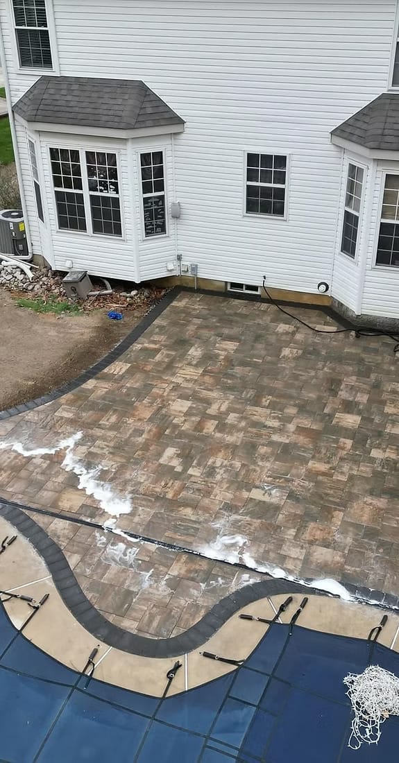 Paver patio installation beside house